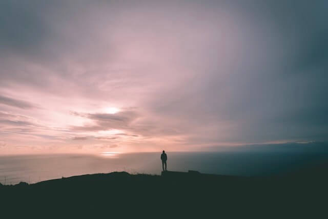 A person in solitude looking at the horizon resembling the Christian inner life